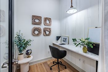 a home office with white walls and a white desk with a computer and a black chair at The Livano Kemah, Kemah, TX